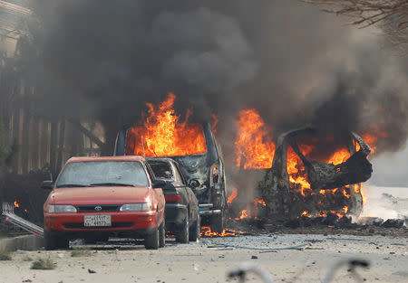 Vehicles are seen on fire after a blast in Jalalabad, Afghanistan January 24, 2018.REUTERS/Parwiz