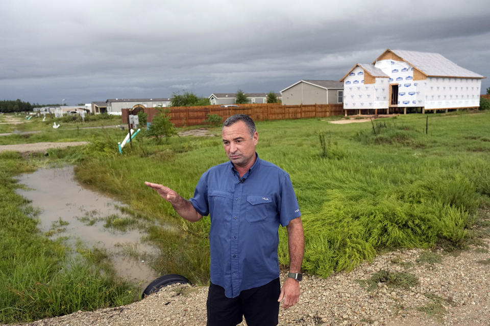 Developer Trey Harris talks about the Colony Ridge development as he stands near a near home under construction next to a row of mobile homes Tuesday, Oct. 3, 2023, in Cleveland, Texas. The booming Texas neighborhood is fighting back after Republican leaders took up unsubstantiated claims that it has become a magnet for immigrants living in the U.S. illegally and that cartels control pockets of the neighborhood. (AP Photo/David J. Phillip)