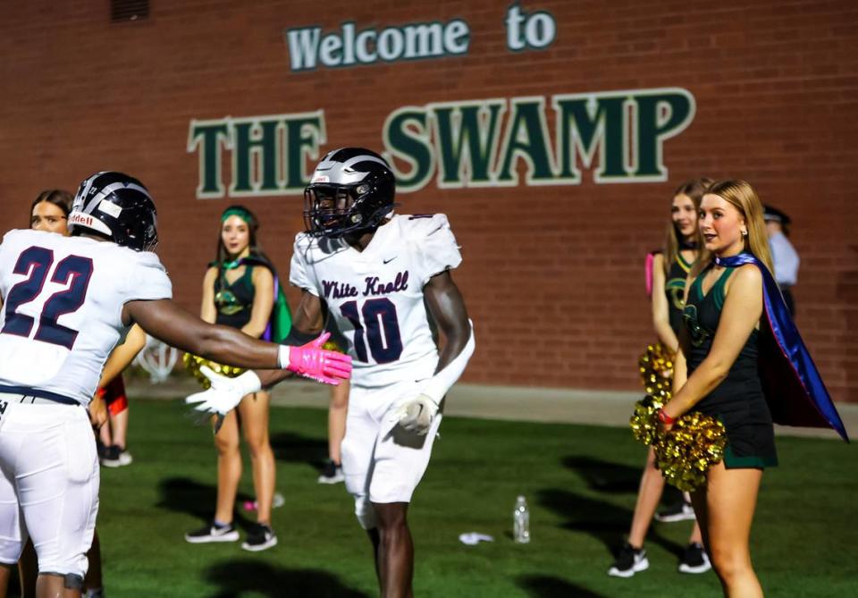 White Knoll Timberwolves linebacker Jaiden Kimble (10) and linebacker Demenico Banks (22) celebrate a touchdown near the River Bluff Gators cheerleaders during their game at River Bluff High School Friday night, Sept. 29, 2023.