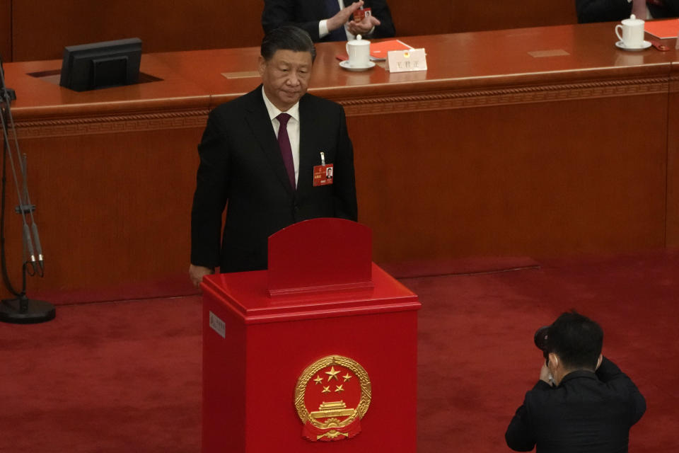 Chinese President Xi Jinping looks up after casting his vote to select state leaders during a session of China's National People's Congress (NPC) at the Great Hall of the People in Beijing, Friday, March 10, 2023. (AP Photo/Mark Schiefelbein)