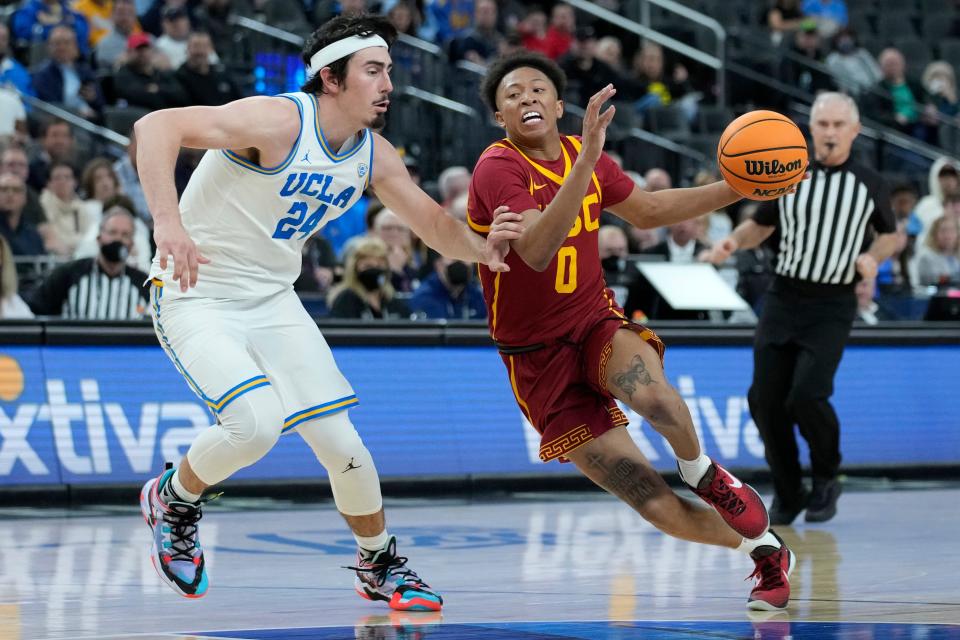 FILE - Southern California's Boogie Ellis (0) drives against UCLA's Jaime Jaquez Jr. (24) during the second half of an NCAA college basketball game in the semifinal round of the Pac-12 tournament Friday, March 11, 2022, in Las Vegas. Ellis was selected to the All-Pac-12 team in voting released by The Associated Press, Tuesday, March 7, 2023. (AP Photo/John Locher, File)