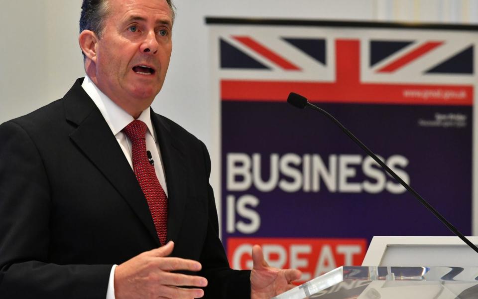 Liam Fox's department is racing to work out trade deals  - AFP