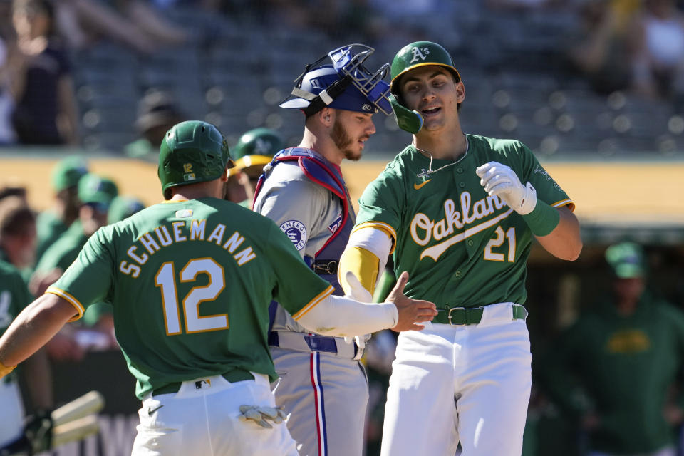 Oakland Athletics' Tyler Soderstrom, right, celebrates with Max Schuemann, left, after hitting a two-run home run against the Texas Rangers during the fourth inning in the second baseball game of a doubleheader Wednesday, May 8, 2024, in Oakland, Calif. (AP Photo/Godofredo A. Vásquez)