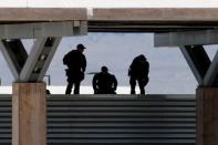 Security officers keep watch over a tent encampment housing immigrant children just north of the Mexican border in Tornillo, Texas, U.S. June 20, 2018. REUTERS/Mike Blake