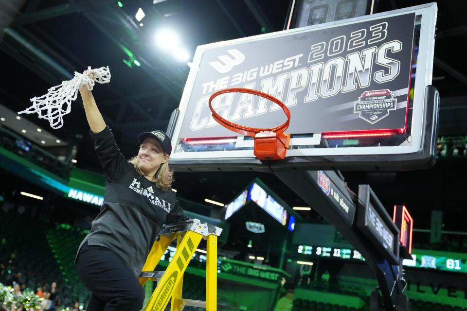 Hawaii coach Laura Beeman holds up the net after the team's win over UC Santa Barbara in an NCAA college basketball game for the women's Big West Tournament championship Saturday, March 11, 2023, in Henderson, Nev. (AP Photo/Eric Jamison)