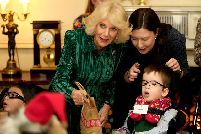 <p>Kin Cheung WPA Pool/Getty</p> Queen Camilla at the tree decorating event at Clarence House on Dec. 6.