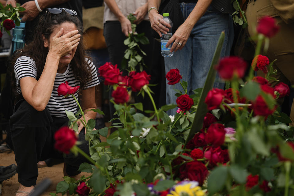 Friends and relatives of Yonat Or cry next to her grave during her funeral at Kibbutz Palmachim, Israel, Sunday, Oct. 29, 2023. Or was killed by Hamas militants on Oct. 7, in Kibbutz Be'eri near the border with the Gaza Strip. More than 1,400 people were killed and some 220 captured in an unprecedented, multi-front attack on Israel by the militant group that rules Gaza. (AP Photo/Ariel Schalit)