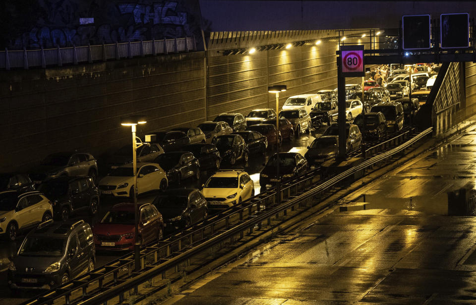 Vehicles parked on the closed motorway following several accidents on the city highway A100 in Berlin, Germany, Tuesday, Aug. 18, 2020. According to German news agency dpa, prosecutors say the series of crashes caused by a 30-year-old Iraqi man on the highway was an Islamic extremist attack. (Paul Zinken/dpa via AP)