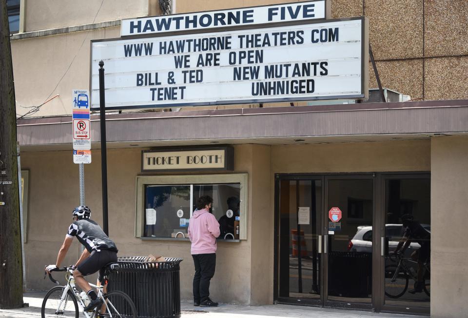 Man buys a ticket at the ticket booth of Hawthorne Theaters, a multiplex on Lafayette Avenue.