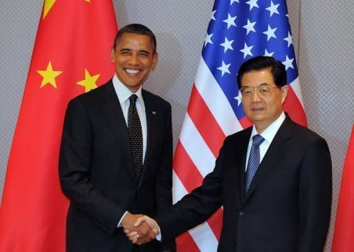 US President Barack Obama shakes hands with Chinese President Hu Jintao before a bilateral meeting in Seoul. China has expressed "serious concern" to its ally North Korea about a planned rocket launch, a US official said after talks between Obama and Hu