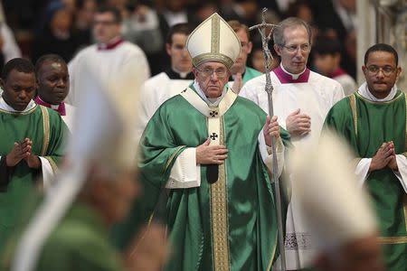 Pope Francis (C) leaves at the end of a mass in St. Peter's Basilica at the Vatican February 15, 2015. REUTERS/Alessandro Bianchi