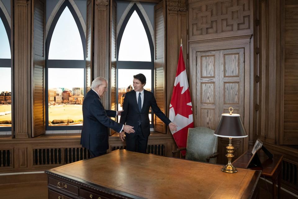 Prime Minister Justin Trudeau, right, is offered a seat at the desk by former prime minister Brian Mulroney while touring a replica of Mr. Mulroney's former parliamentary office in Mulroney Hall at St. Francis Xavier University in Antigonish, N.S. on Monday, June 19, 2023.