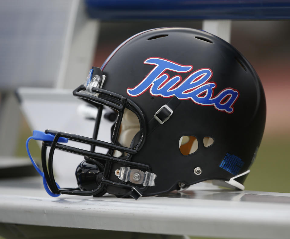 An Tulsa football helmet sits on the team bench before an NCAA college football game against SMU, Saturday, Oct. 31, 2015, in Dallas. (AP Photo/Jim Cowsert)