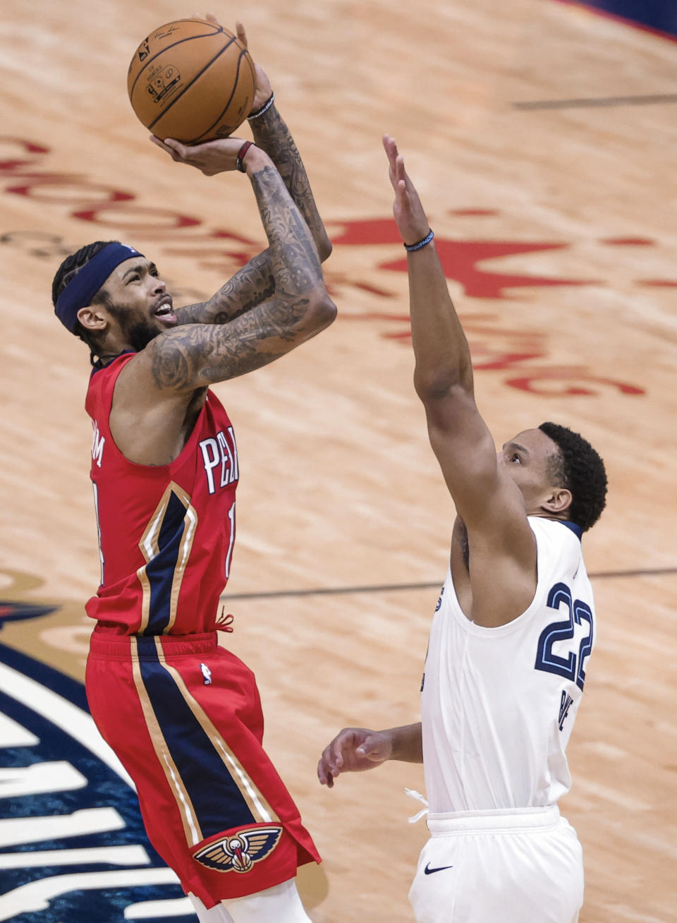 New Orleans Pelicans forward Brandon Ingram (14) shoots over Memphis Grizzlies guard Desmond Bane (22) during the first quarter of an NBA basketball game in New Orleans, Saturday, Feb. 6, 2021. (AP Photo/Derick Hingle)