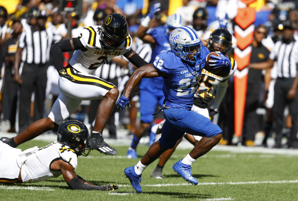 Hampton running back Darran Butts (22) runs for a touchdown against Grambling defensive backs Java'n Singletary (1) and Kevin Thomas (2) during the first half of an NCAA college football game, Saturday, Sept. 2, 2023, in Harrison, N.J. (AP Photo/Noah K. Murray)