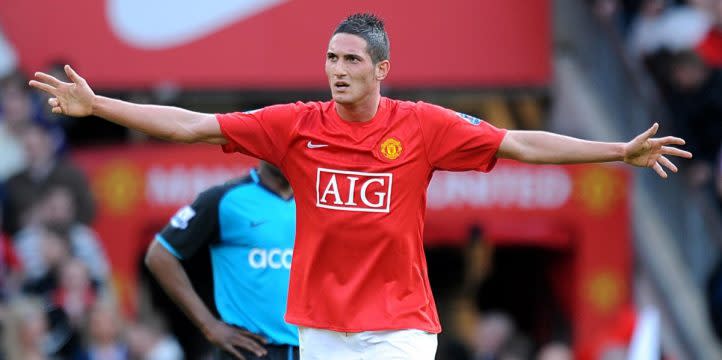 Manchester United's Federico Macheda reacts after being booked by referee Mike Riley for over celebrating his winning goal in the Premier League. Old Trafford, April 2009. Credit: PA Images