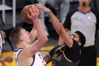 Denver Nuggets center Nikola Jokic, left, has his shot blocked by Los Angeles Lakers forward Anthony Davis during the first half of an NBA basketball game Monday, May 3, 2021, in Los Angeles. (AP Photo/Mark J. Terrill)