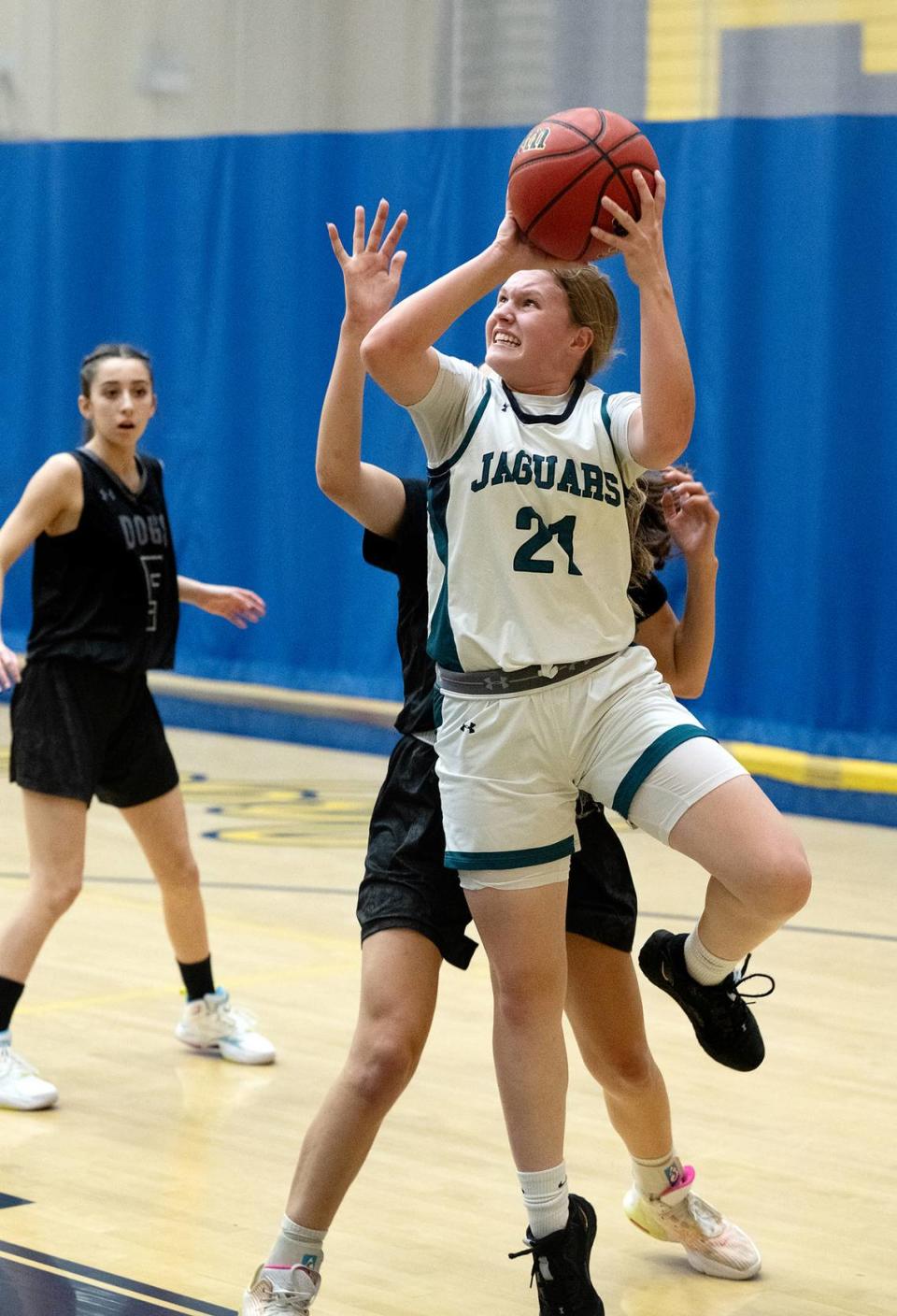 Gregori’s Audrey Pacheco takes a shot under pressure from a Tracy defender during the tournament game at Gregori High School in Modesto, Calif., Friday, Dec. 8, 2023.