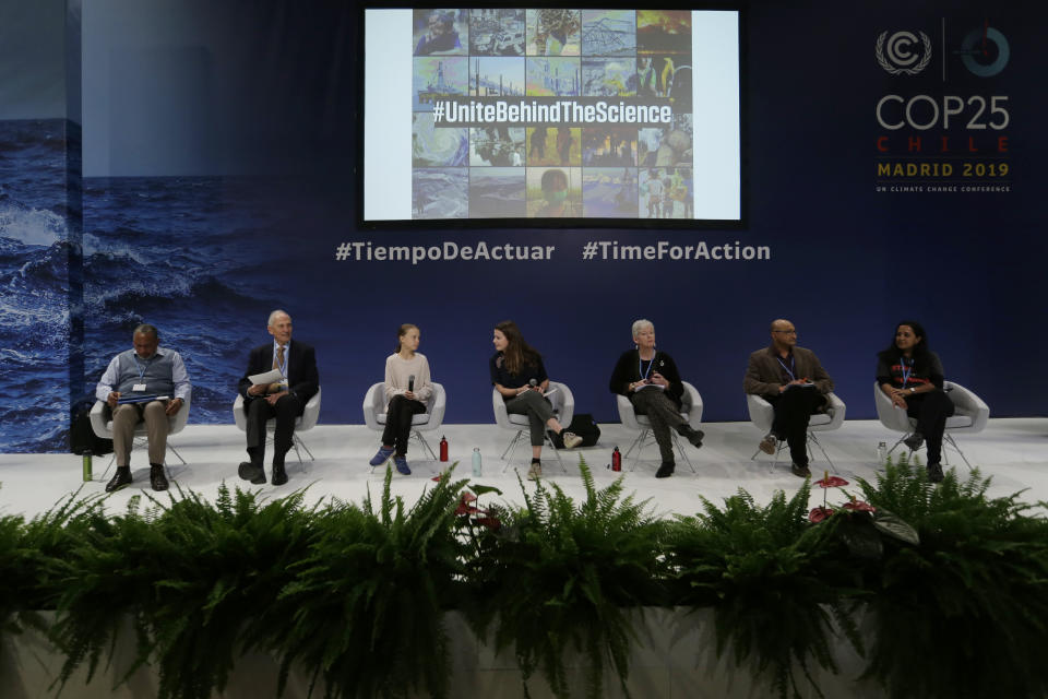Youth climate activists Greta Thunberg, 3rd left, and Luisa Neubauer, 4th left, take part in a meeting with leading climate scientists at the COP25 summit in Madrid, Spain, Tuesday, Dec. 10, 2019. Thunberg is in Madrid where a global U.N.-sponsored climate change conference is taking place. (AP Photo/Paul White)
