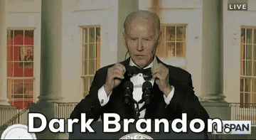 Biden putting on his sunglasses with caption "Dark Brandon"