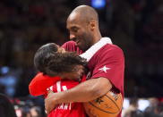 In this Feb. 14, 2016, file photo, Los Angeles Lakers Kobe Bryant (24) hugs his daughter Gianna on the court in warm-ups before first half NBA All-Star Game basketball action in Toronto. Bryant, his 13-year-old daughter, Gianna, and several others are dead after their helicopter went down in Southern California on Sunday, Jan. 26, 2020. (Mark Blinch/The Canadian Press via AP)