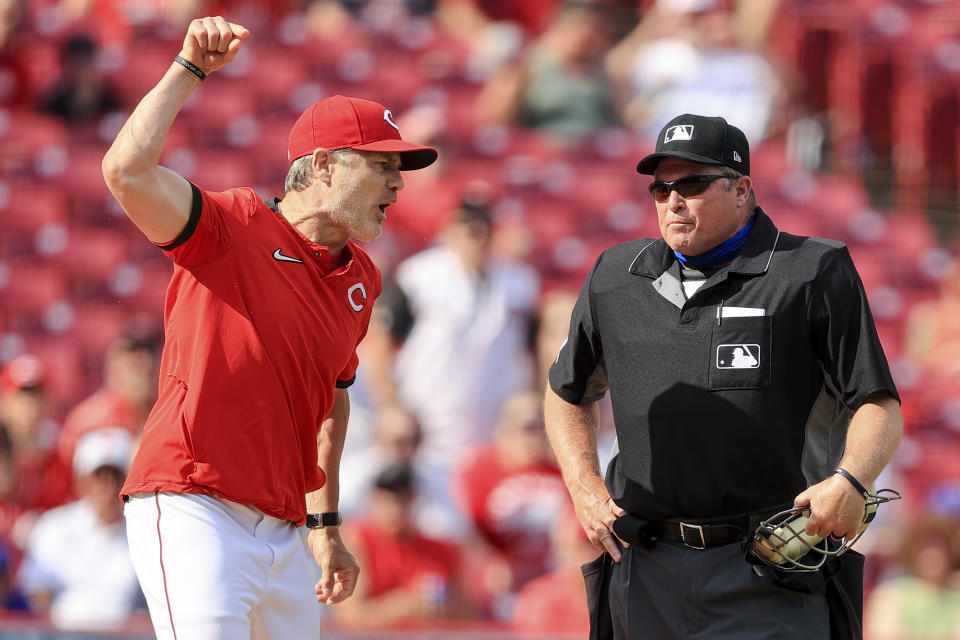 Cincinnati Reds' David Bell, left, reacts after being ejected from a baseball game by MLB umpire Marvin Hudson, right, during the fifth inning against the Colorado Rockies in Cincinnati, Saturday, June 12, 2021. (AP Photo/Aaron Doster)