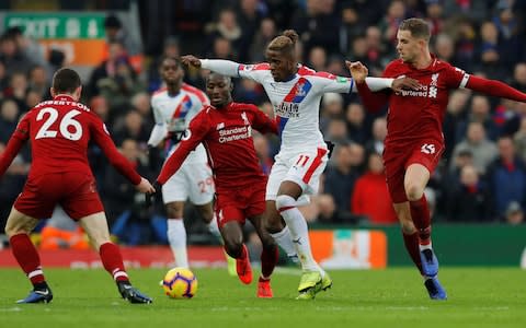 Soccer Football - Premier League - Liverpool v Crystal Palace - Anfield, Liverpool, Britain - January 19, 2019 Crystal Palace's Wilfried Zaha in action with Liverpool's Jordan Henderson, Naby Keita and Andrew Robertson REUTERS/Phil Noble EDITORIAL USE ONLY. No use with unauthorized audio, video, data, fixture lists, club/league logos or "live" services. Online in-match use limited to 75 images, no video emulation. No use in betting, games or single club/league/player publications. Please contact your account representative for further details - Credit: REUTERS