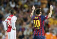 Barcelona's Lionel Messi (R) celebrates scoring his second goal against Ajax as Ajax's Stefano Denswil (L) reacts during their Champions League soccer match at Camp Nou stadium in Barcelona September 18, 2013. REUTERS/Gustau Nacarino (SPAIN - Tags: SPORT SOCCER)