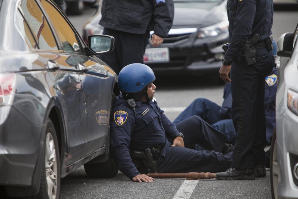 Policemen rest during a riot over the death of Freddie Gray in Baltimore, Maryland, USA, on April 27, 2015. (Photo by Samuel Corum/Anadolu Agency/Getty Images)