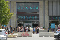 Customers queue outside the Primark store in Rushden Lakes. The Government has made it mandatory to wear face coverings in all public transport, supermarkets and indoor shopping centers as a measure to combat the spread of the novel coronavirus. (Photo by David Mbiyu / SOPA Images/Sipa USA)