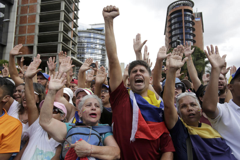 Anti-government protesters cheer after Juan Guaido, head of Venezuela's opposition-run congress, declares himself interim president of the South American country until new elections can be called, at a rally demanding the resignation of President Nicolas Maduro, in Caracas, Venezuela, Wednesday, Jan. 23, 2019. (AP Photo/Boris Vergara)