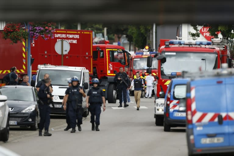 Police officers and fire services arrive at the scene of a hostage-taking at a church in Saint-Etienne-du-Rouvray, near the city of Rouen in northern France, on July 26, 2016