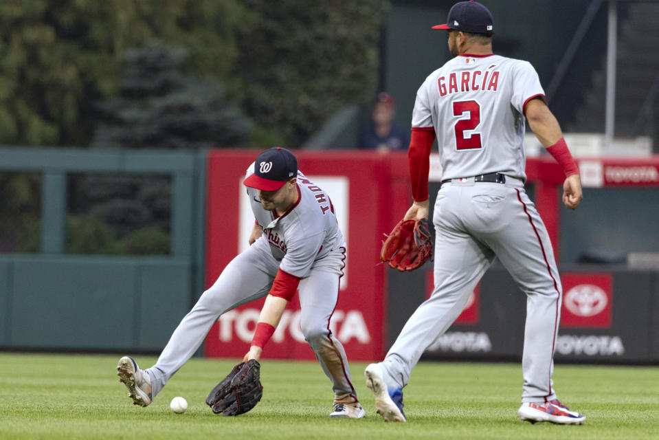 Washington Nationals right fielder Lane Thomas, left, fields a single from Philadelphia Phillies' Nick Castellanos as second baseman Luis Garcia (2) watches during the sixth inning of a baseball game Friday, June 30, 2023, in Philadelphia. (AP Photo/Laurence Kesterson)