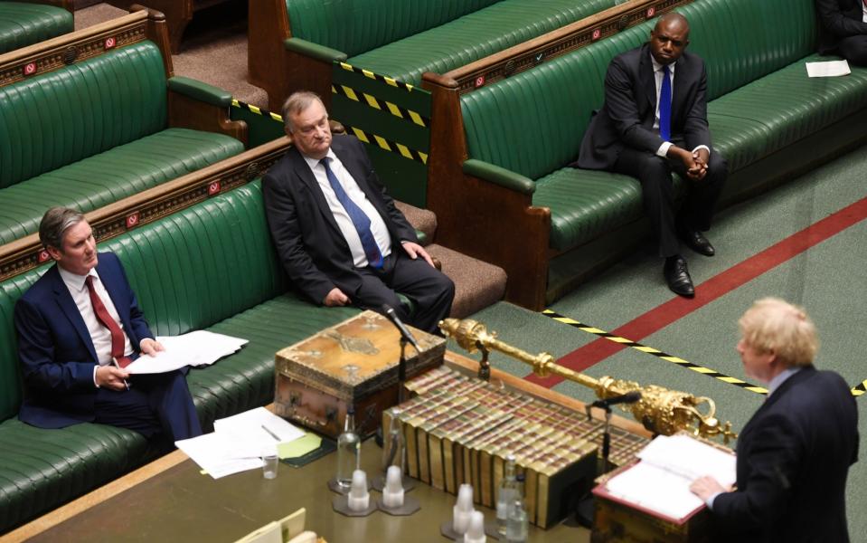 Britain's Prime Minister Boris Johnson speaks at the House of Commons during question period as opposition Labour Party leader Keir Starmer looks on, amid the coronavirus disease outbreak, in London, Britain May 20, 2020 - MPs might have to spend hours voting in the House of Commons because of social-distancing measures, secret trials find - REUTERS