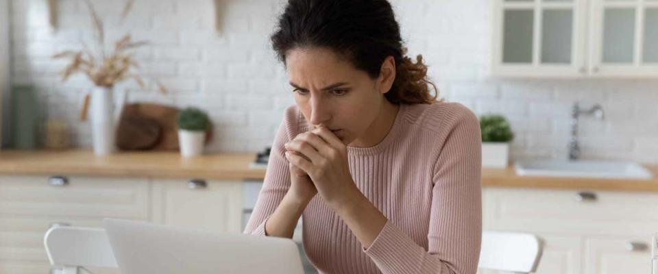 Woman with furrowed brow at computer