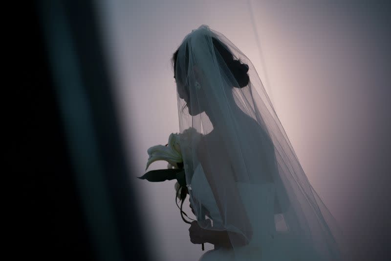 Peng Jing, 24, smiles during her wedding photography shoot after the lockdown was lifted in Wuhan