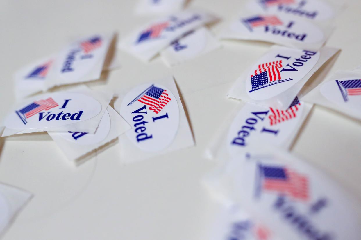 Vote stickers lay on a table as voters take to the polls at Westwood Church of Christ in Edmond, Okla., on Tuesday, April 4, 2023.