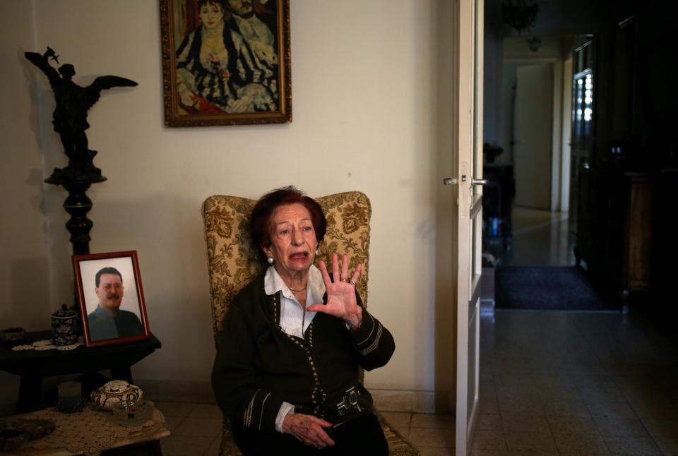In this Thursday April 10, 2014 photo, Lebanese Mary Mansourati, 82, whose son Dani went missing in Syria in 1992 at the age of 30, his portrait seen at left, speaks during an interview with the Associated Press at her house, in Beirut, Lebanon. Dani is among an estimated 17,000 Lebanese still missing from the time of Lebanon’s civil war or the years of Syrian domination that followed. Syria’s civil war has added new urgency to the plight of their families, many of whom are convinced their loved ones are still alive and held in Syrian prisons, at risk of being lost or killed in the country’s mayhem. (AP Photo/Hussein Malla)