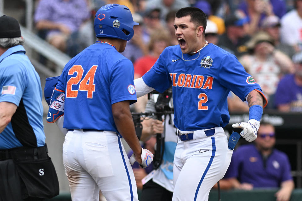 Florida’s Ty Evans, right, hit the first grand slam in a MCWS final on Sunday afternoon.