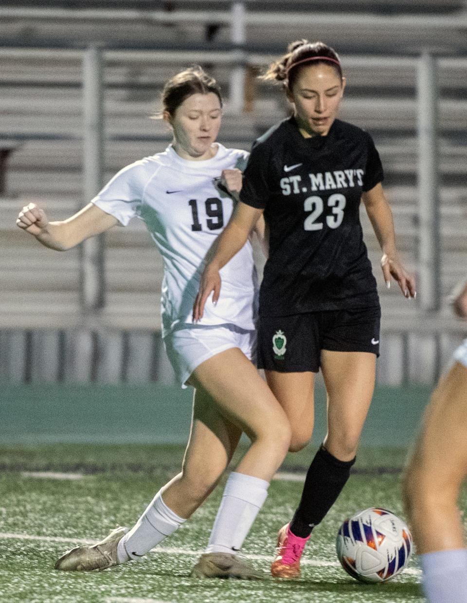 Enoch's Zoe Carlson, left, and St. Mary's Alyssa Polk fight for the ball during a Sac-Joaquin Section girls soccer playoff game at St. Mary's Sanguinetti Field in Stockton on Feb. 10, 2024.