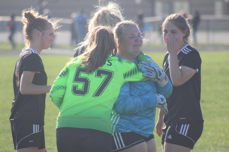 Cheboygan players console senior goalkeeper Callie Wanke following the Chiefs' district loss to TC St. Francis on Thursday.