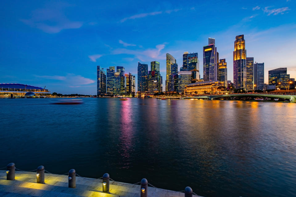 Cityscape Singapore in the early evening, city lights reflecting of the water