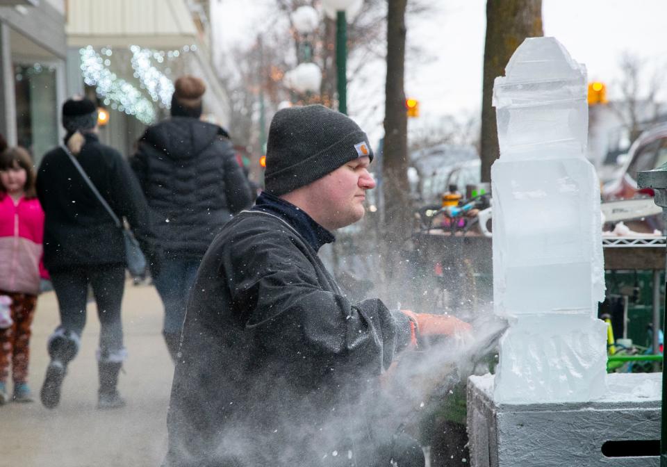 Matthew Larson of Ice Creations in Napoleon, Ohio, carves an ice sculpture Jan. 21, 2023, during the Tecumseh Ice Sculpture Festival.