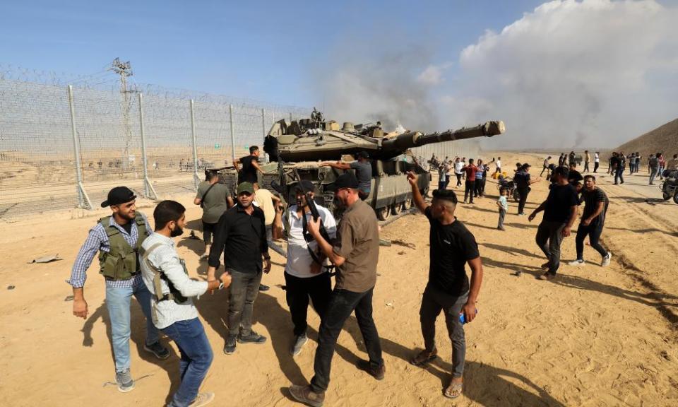 Hamas militants with a captured Israeli tank