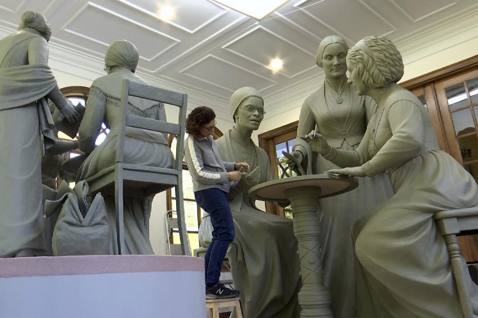 In this Nov. 4, 2019, still image from video, sculptor Meredith Bergmann works on the first women's statue that will be installed in New York's Central Park, in her studio in Ridgefield, Conn. The monument is scheduled to be dedicated Aug. 26, 2020, marking the 100th anniversary of American women winning the right to vote. (AP Photo/Joseph Frederick)