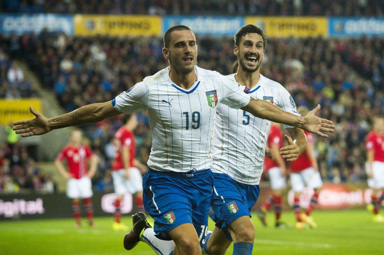 Italy's Leonardo Bonucci (L) celebrates scoring a goal with teammate Davide Astori, during their 2016 Euro qualifying match against Norway, in Oslo, on September 9, 2014