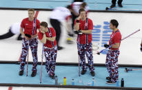 Norway player, from left, Haavard Vad Petersson, Torger Nergaard, Christoffer Svae, and skip Thomas Ulsrud wait for their turn to throw during men's curling competition against Denmark at the 2014 Winter Olympics, Monday, Feb. 17, 2014, in Sochi, Russia. (AP Photo/Robert F. Bukaty)