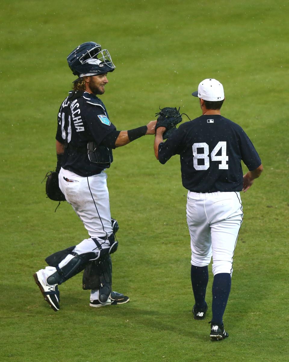 Tigers catcher Jarrod Saltalamacchia (19) celebrates with pitcher John Schreiber (84) after the Tigers' 8-3 exhibition win on Tuesday, March 20, 2018, in Lakeland, Fla.