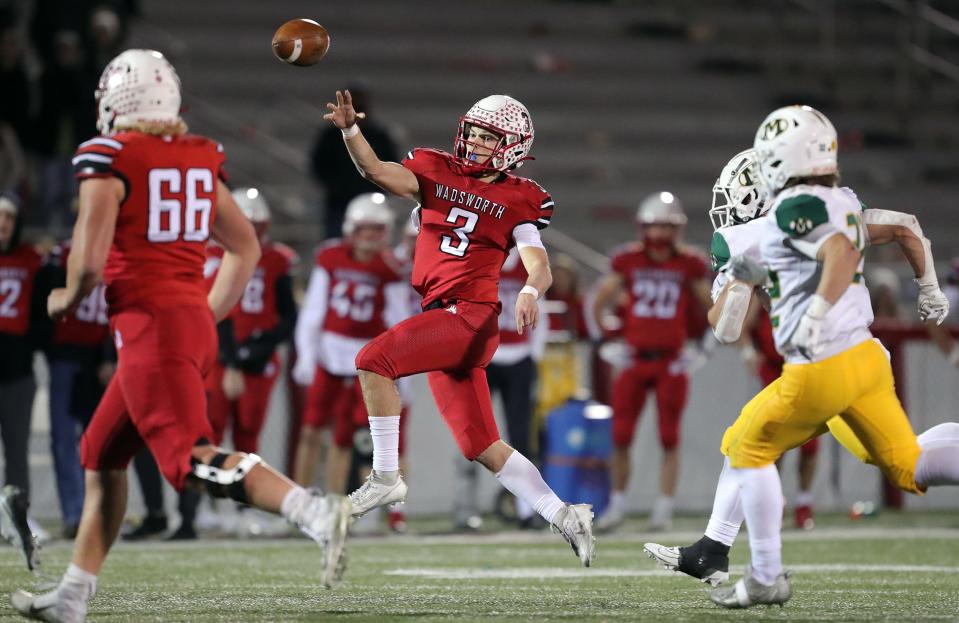 Wadsworth quarterback Will Stack throws on the run during a Division I regional quarterfinal against Medina on Friday in Wadsworth, Ohio.