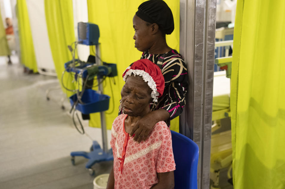 FILE - A woman accompanied by her daughter, waits to be treated at a Doctors Without Borders emergency room in the Cite Soleil neighborhood of Port-au-Prince, Haiti, Friday, April 19, 2024. Haiti's health system has long been fragile, but it's now nearing total collapse after gangs launched coordinated attacks on Feb. 29, targeting critical state infrastructure in the capital and beyond. (AP Photo/Ramon Espinosa, File)